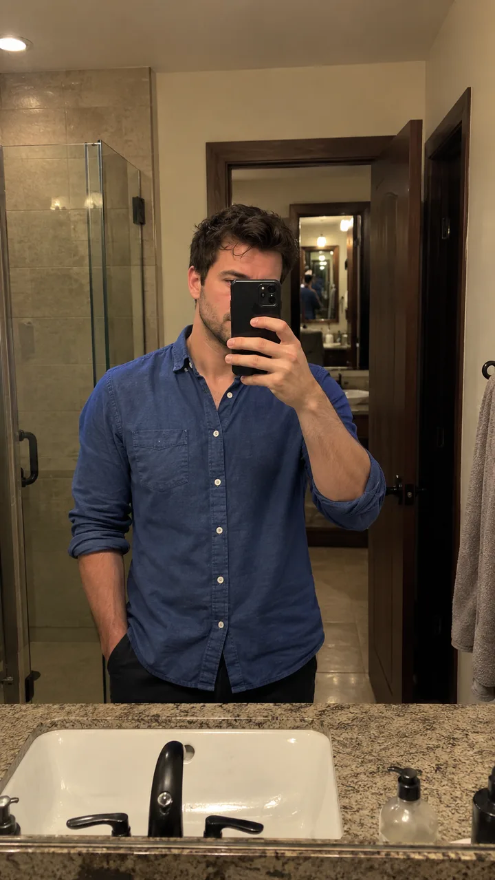 Preparation concept: a mirror selfie with a phone obscuring part of the face and a repeated reflection